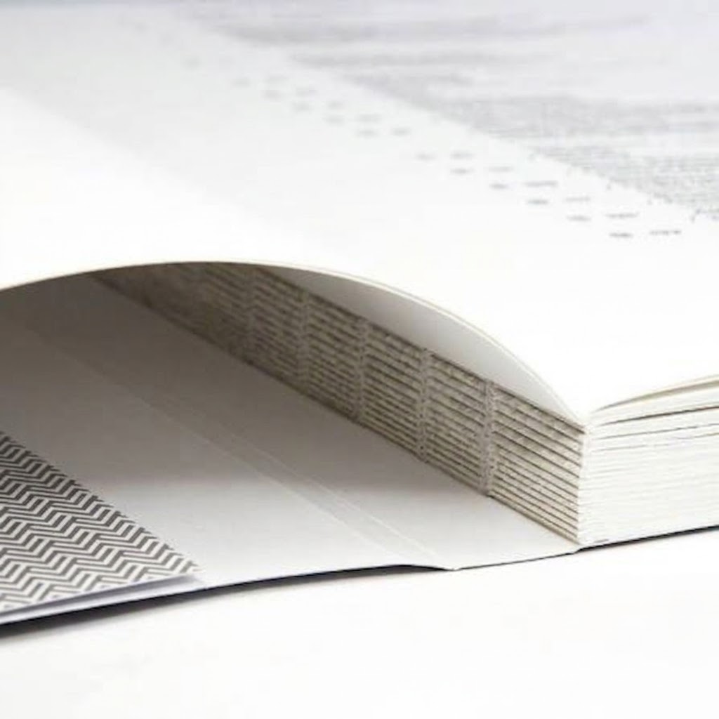 Open book showing folded signatures and thread sewn construction along the spine